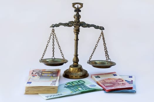 Euro notes in front of a scale. How secure is the euro?
