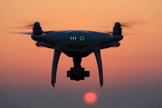 KAGAWA, JAPAN - JUNE 15, 2017: Remote controlled drone Dji Phantom 4 Pro equipped with high resolution video camera flying in air and sunset sky.