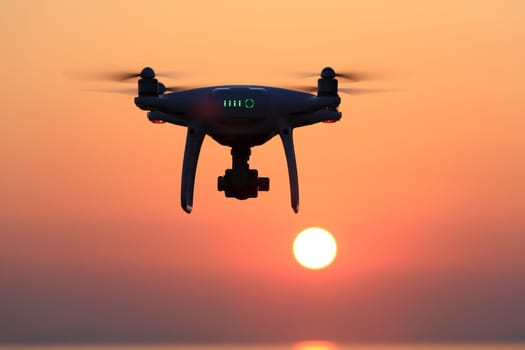 KAGAWA, JAPAN - JUNE 15, 2017: Remote controlled drone Dji Phantom 4 Pro equipped with high resolution video camera flying in air and sunset sky.