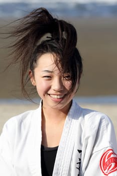 Kagawa, Japan - January 3, 2017: Japanese martial arts houses, young girl training of karate at the new year at the Ichinomiya beach.