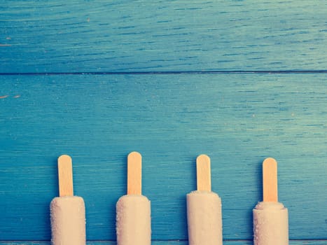 Strawberry ice cream on a blue wooden background