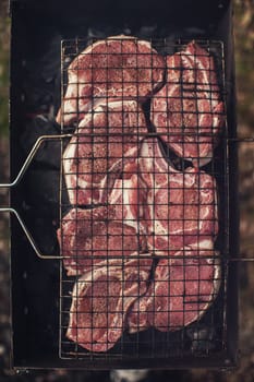 Grilling pork entrecote meat on a grill