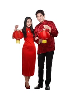 Chinese couple wear cheongsam holding lantern isolated over white background