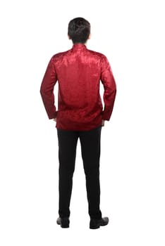Back view of young chinese man in cheongsam suit isolated over white background