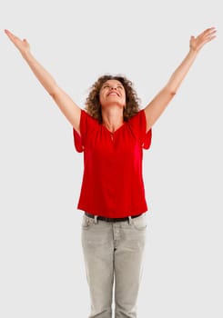 Portrait of a happy middle aged brunette with arms up
