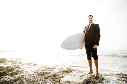 A Businessman holding is surfboard after a long day of work