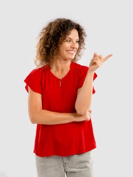 Portrait of a smiling middle aged showing something on her hand
