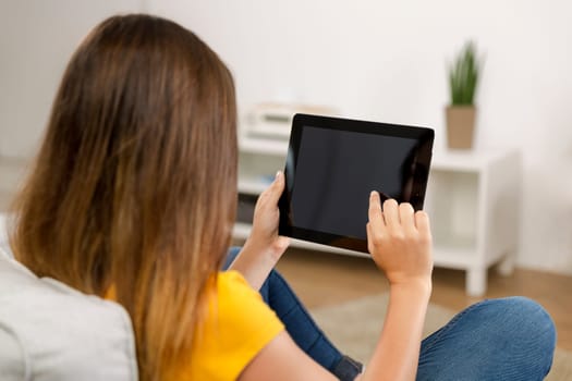 Beautiful woman at home working with a tablet