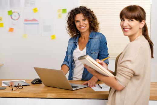 Shot of two businesswoman working together in an office