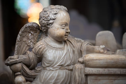 White statue of angel boy in church. Sweden, Scandinavia. Europe travel.