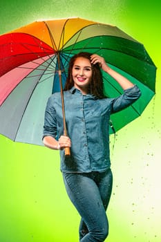 Young beautiful woman with an umbrella. Studio shot
