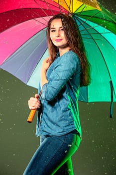Young beautiful woman with an umbrella. Studio shot