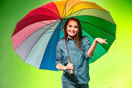 Young beautiful woman with an umbrella. Studio shot