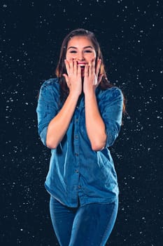 Young beautiful woman with splash of rain. Studio shot