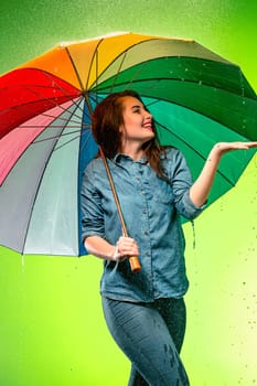 Young beautiful woman with an umbrella. Studio shot