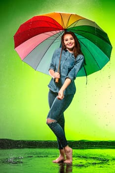 Young beautiful woman with an umbrella. Studio shot