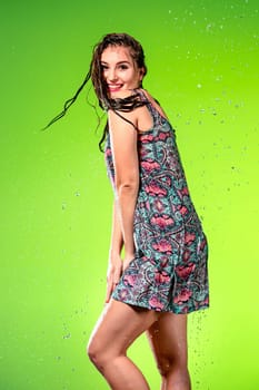 Young beautiful woman with splash of rain. Studio shot