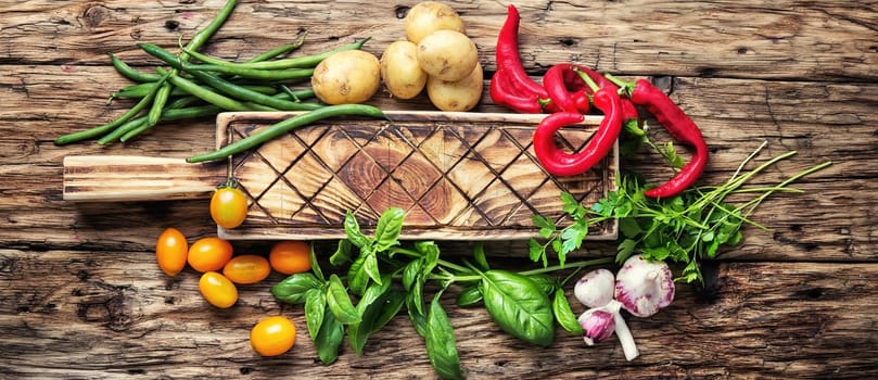 Fresh vegetables. Composition with assortment raw vegetables.Beans in pods, basil, orange tomato, pepper and potatoes