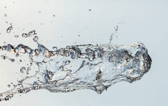 Splashes of water in the air against a bright background