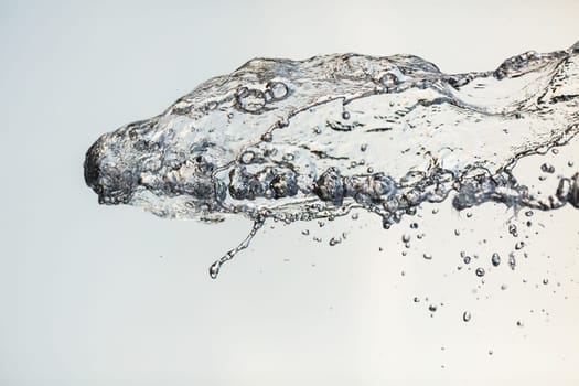 Splashes of water in the air against a bright background