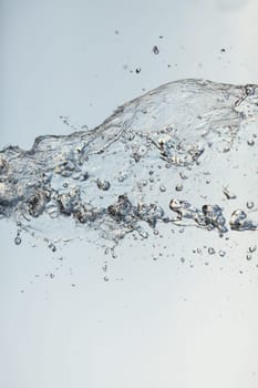 Splashes of water in the air against a bright background