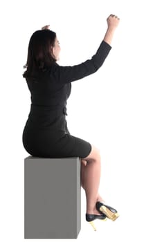 Asian business woman sitting on the block isolated over white background
