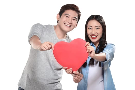 Valentine couple concept. Portrait of man and woman holding red heart