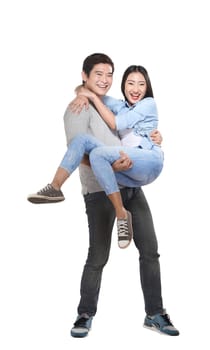 Young man carrying his laughing partner isolated over white background