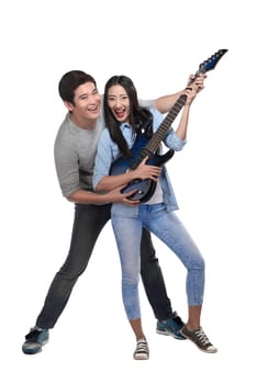 Happy asian couple playing guitar isolated over white background