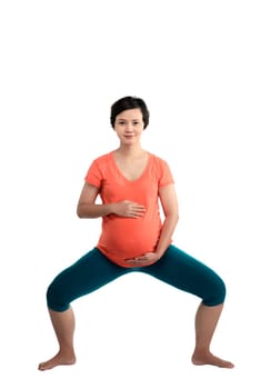 Asian pregnant woman doing yoga over isolated white background