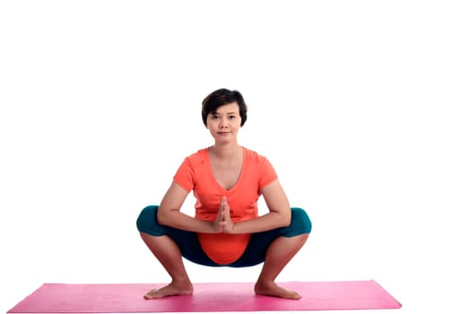 Asian pregnant woman doing yoga over isolated white background