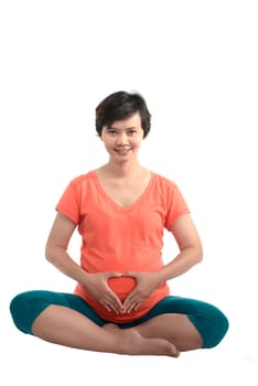 Asian pregnant woman doing yoga over isolated white background