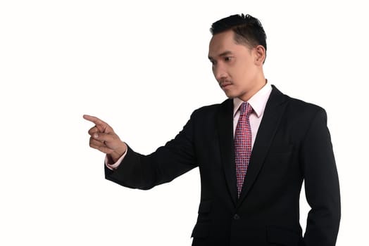Asian business man pointing something isolated over white background