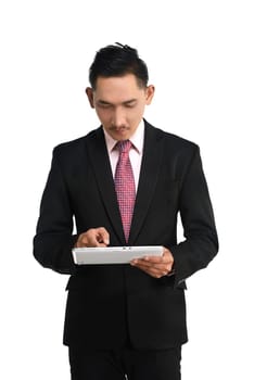Business man holding computer tablet isolated over white background