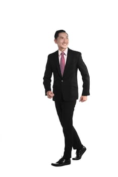 Asian business man walking isolated over white background