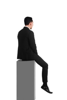 Backview asian business man feeling sad sitting on the box isolated over white