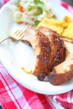 Baby back ribs glazed with a garlic barbecue sauce with cornbread and coleslaw