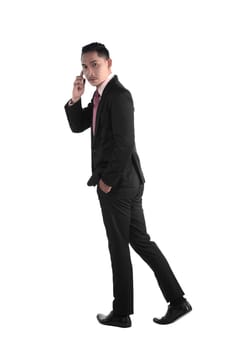 Business man walking while talking via cellphone isolated over white background