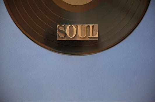 Black vinyl record with the word soul in metal type with room for copy