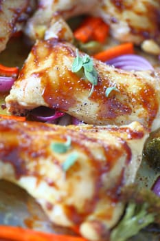 Chicken pieces roasted with hoisin sauce and coarse salt with onions, carrots and broccoli