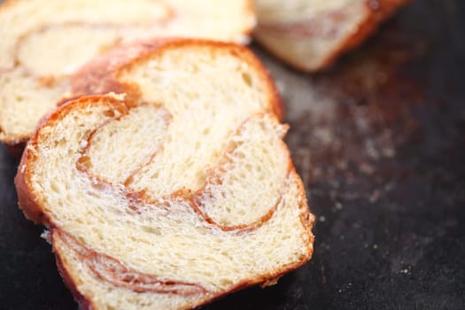 Slice of cinnamon-swirled brioche with copy space