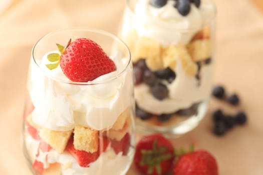 Small strawberry and blueberry trifles in glasses