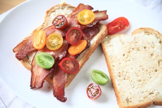 Bacon and cherry tomato sandwich on white bread with mayonnaise