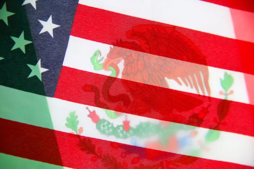 American flag over Mexican flag closeup