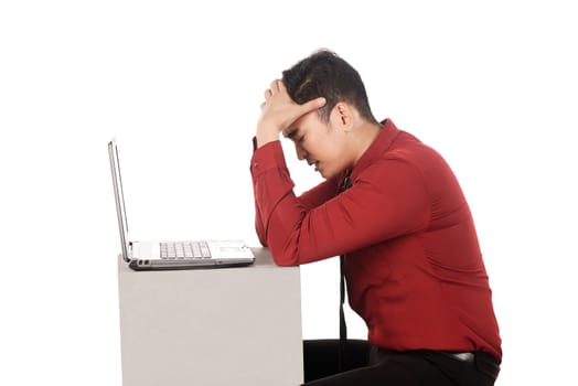 Asian business man stress working with laptop isolated over white background