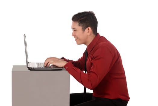 Business man working on a laptop isolated over white background