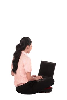 Asian business woman working on a laptop and sitting on the floor isolated over white background