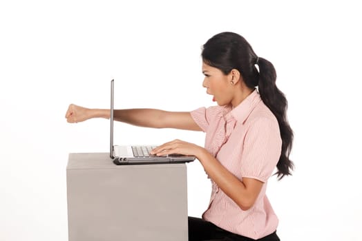 Angry business woman punch laptop isolated over white background