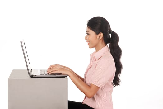 Business woman working on laptop isolated over white background