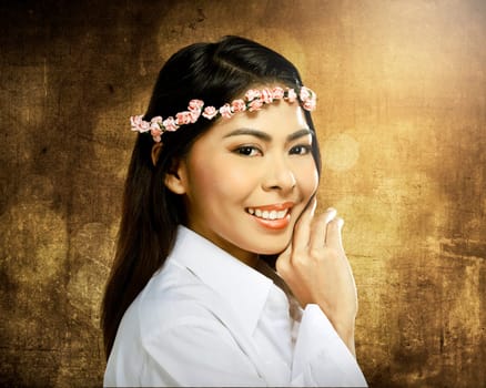 Pretty asian woman wearing flower headband over blur background